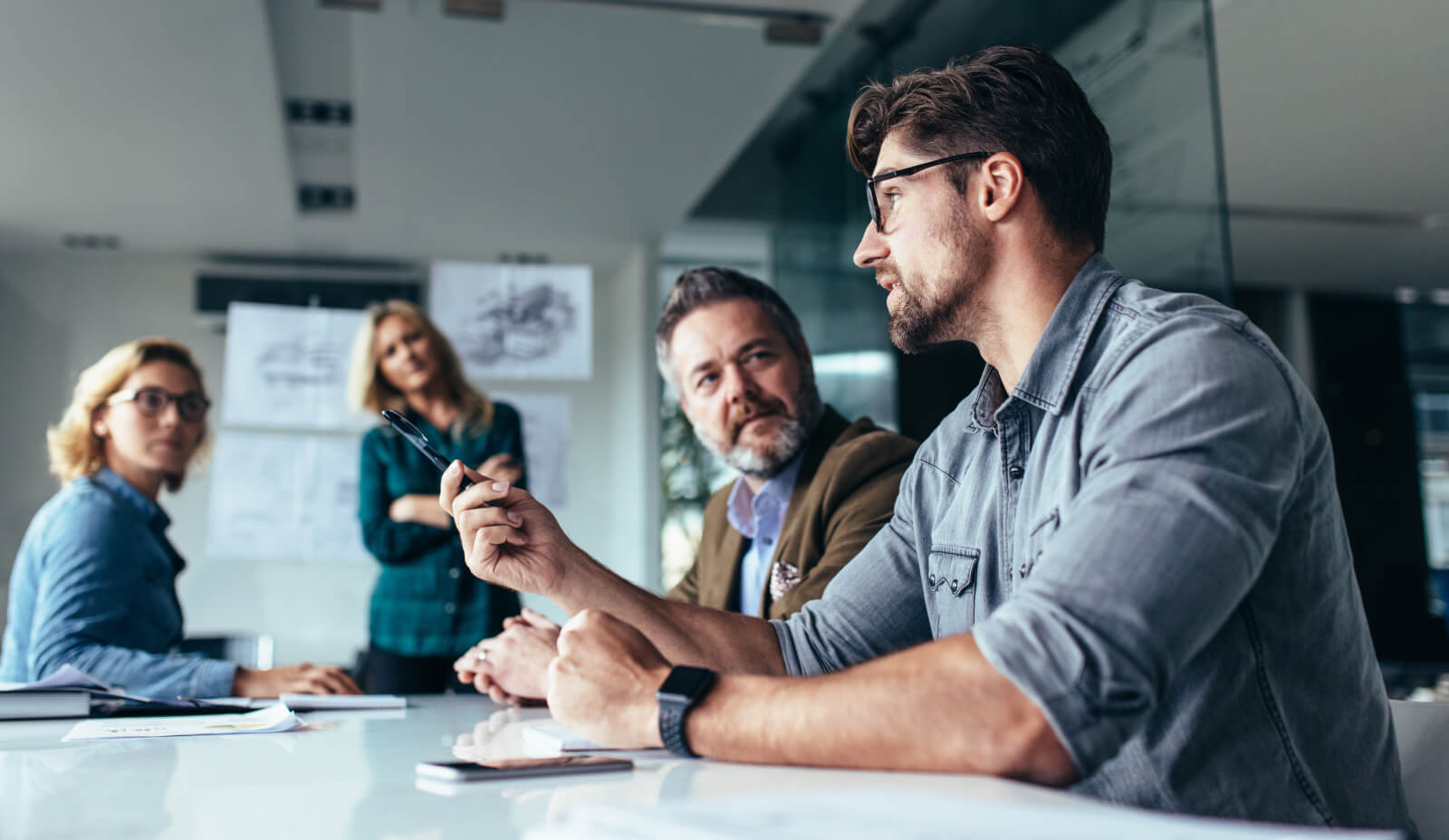 Four professionals exchanging views at a meeting table