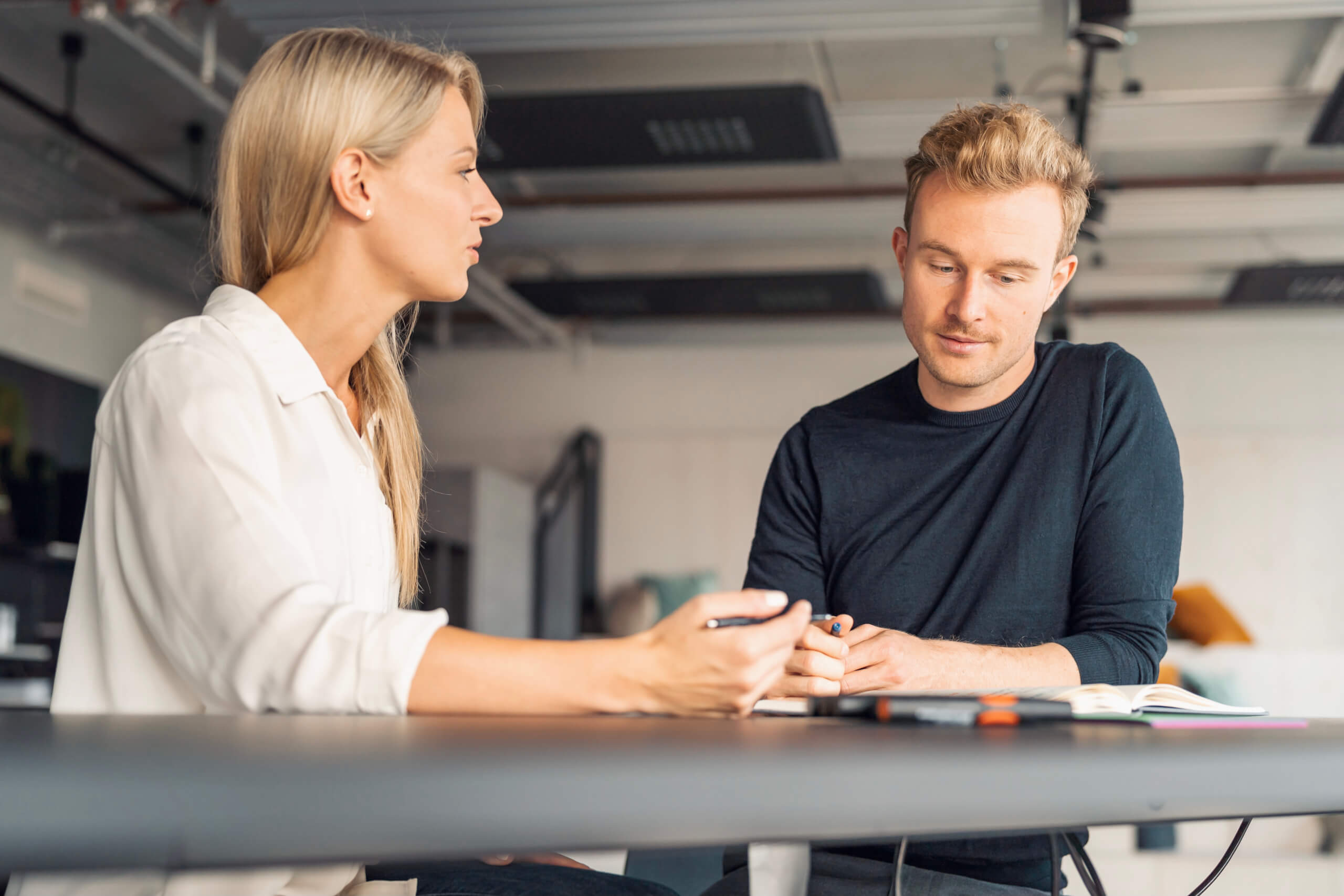 man in blue long sleeve shirt holding smartphone