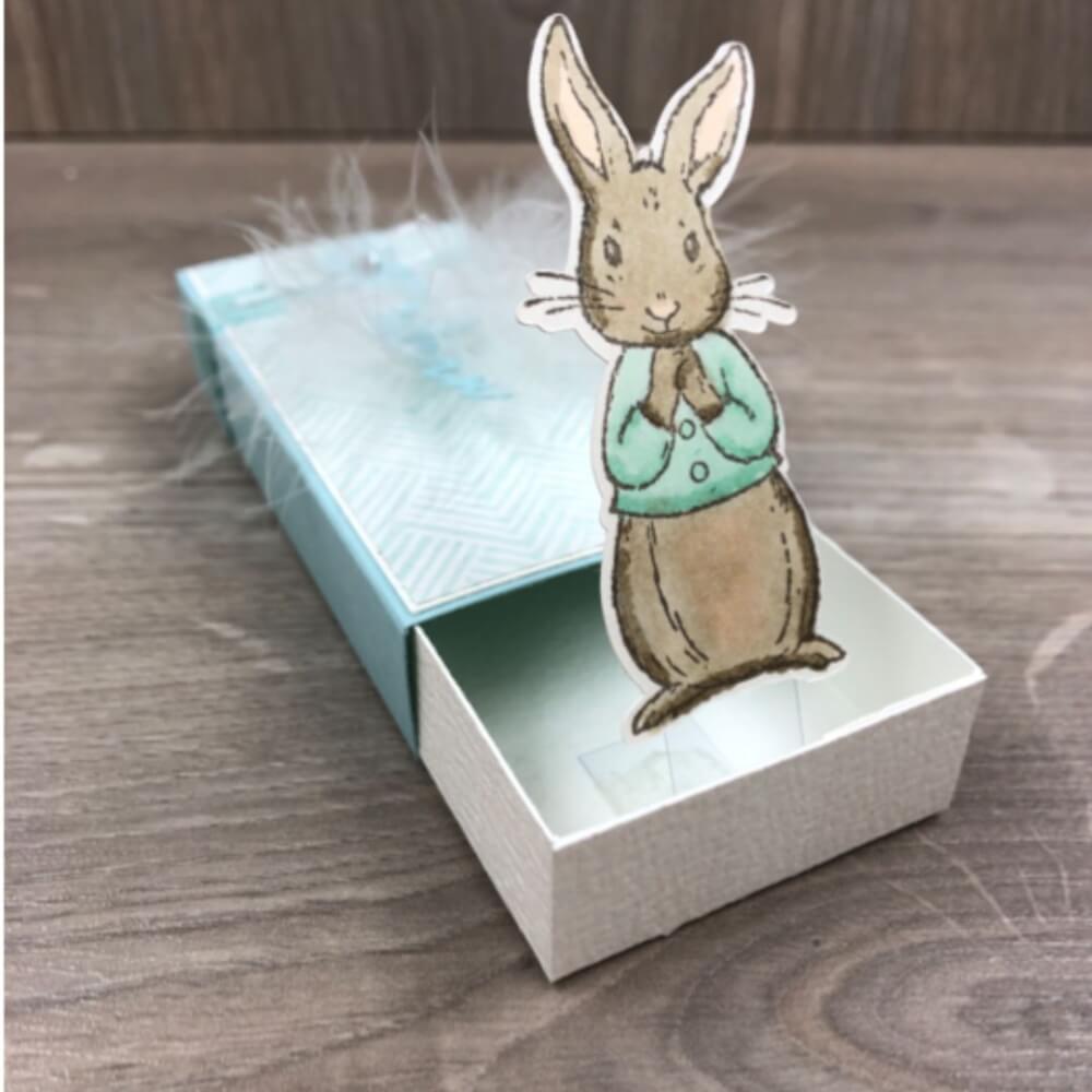 Pop-out Box in Weiß und Türkis mit aufspringendem, gestempelten Osterhasen und weißen Federn, Stampin’ Up! Ostergoodie