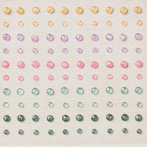Blatt mit runden Opalakzenten in Gelb, Lila, Rosa, Mint und Grün