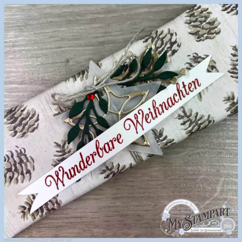 Verpackung mit Wunderbare-Weihnachten-Schriftzug, goldenem Stern und Blättern