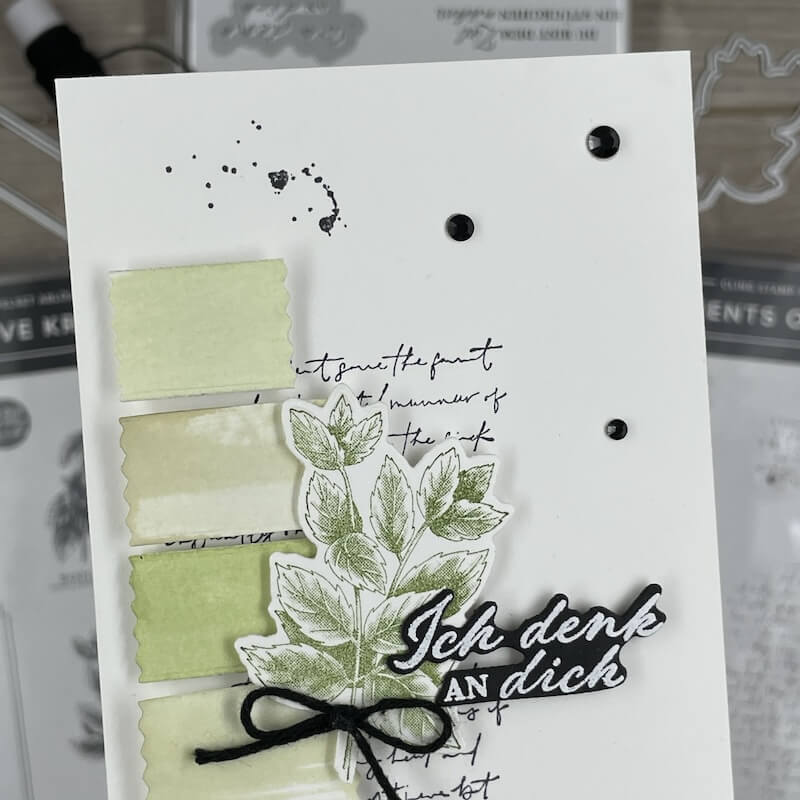 Detail der Karte: gefärbte Etiketten, Schriftstempel im Hintergrund und schwarze Akzente