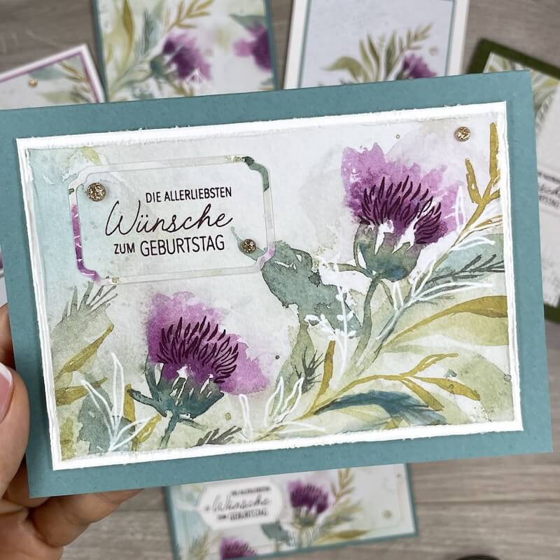 Florale Karte mit Geburtstagswünschen auf türkisem Untergrund