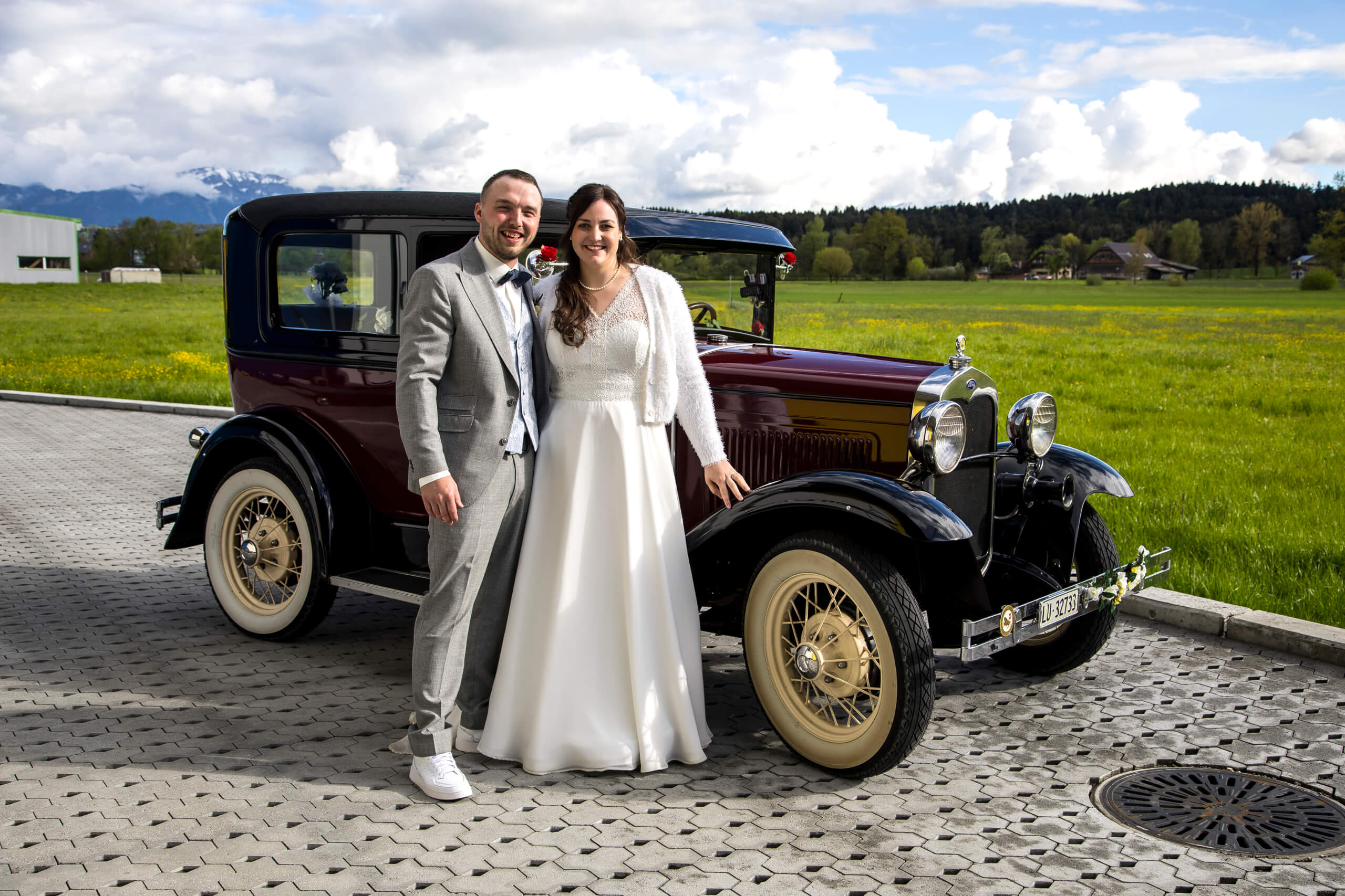 man in black suit kissing woman in white wedding dress