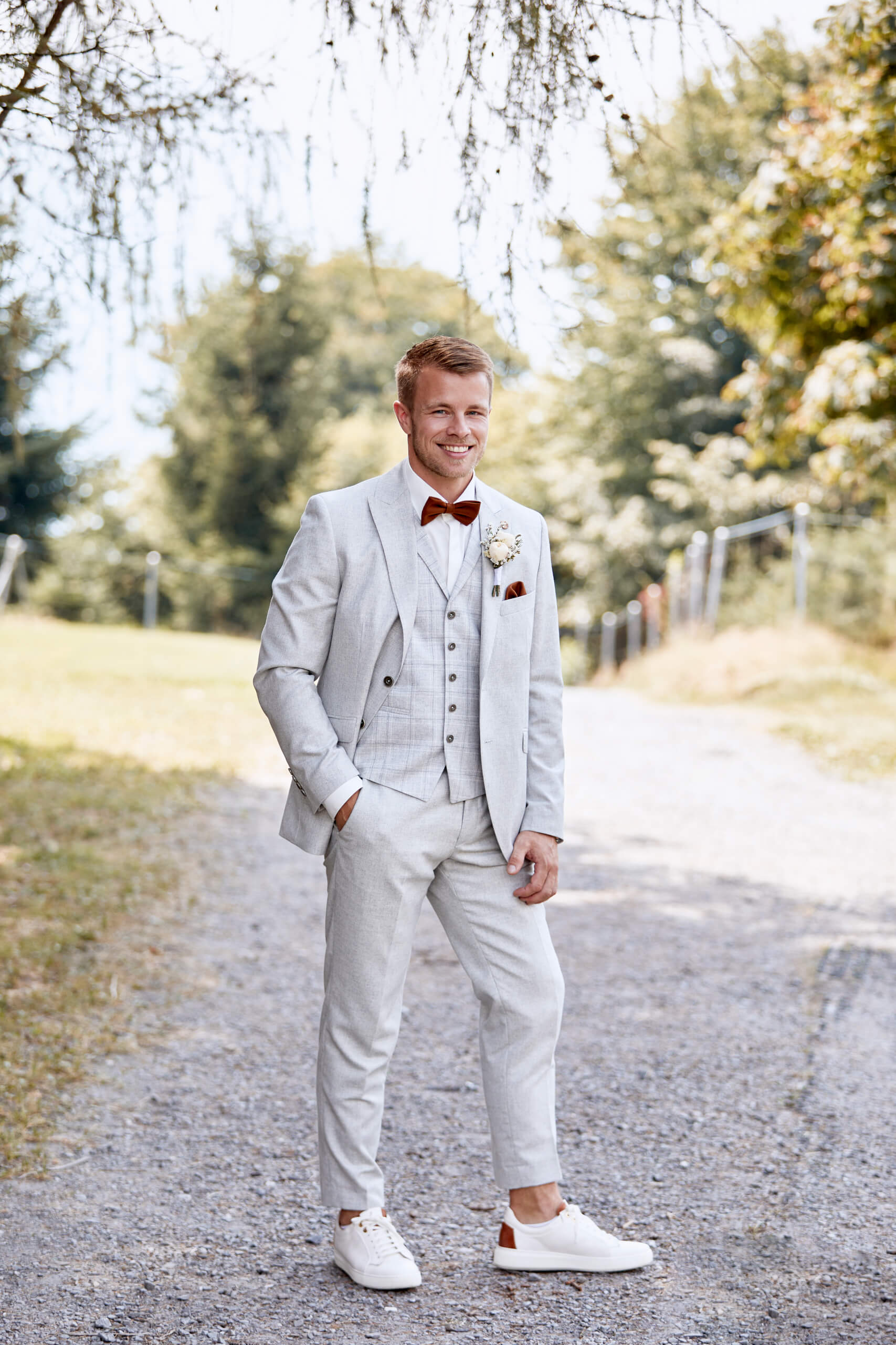 man in black suit kissing woman in white wedding dress