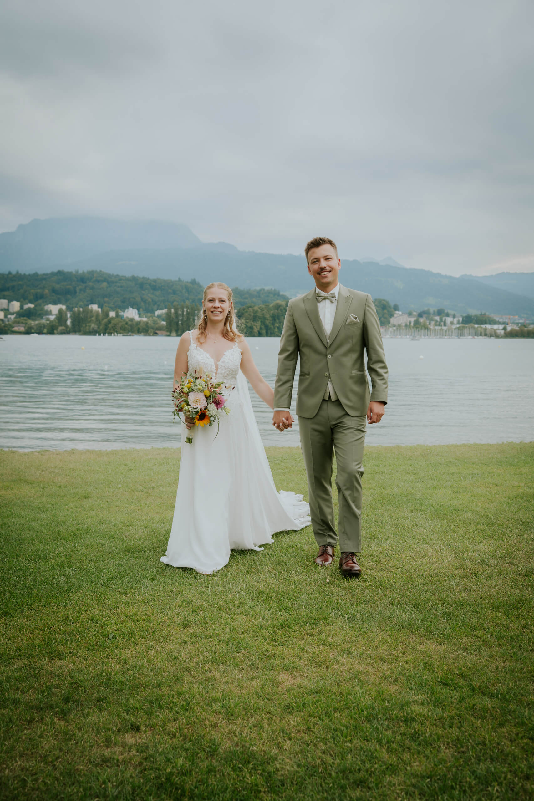 man in black suit kissing woman in white wedding dress