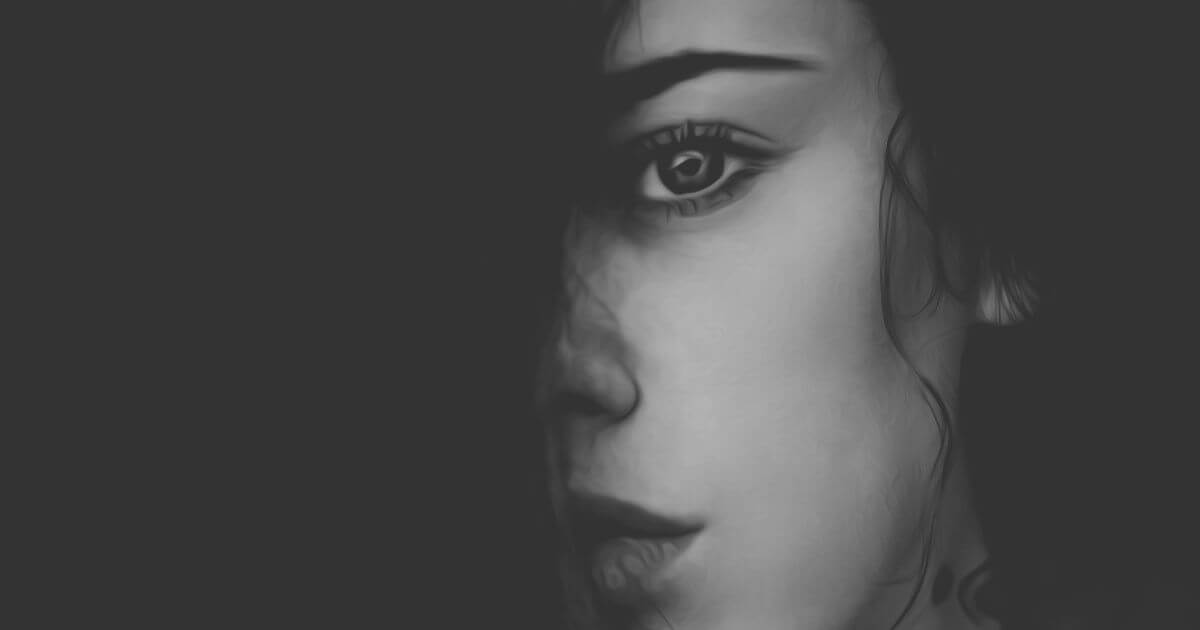 Porträt einer Frau im Schatten als Symbol für Scham, inneren Rückzug und das Gefühl, sich selbst zu verlieren