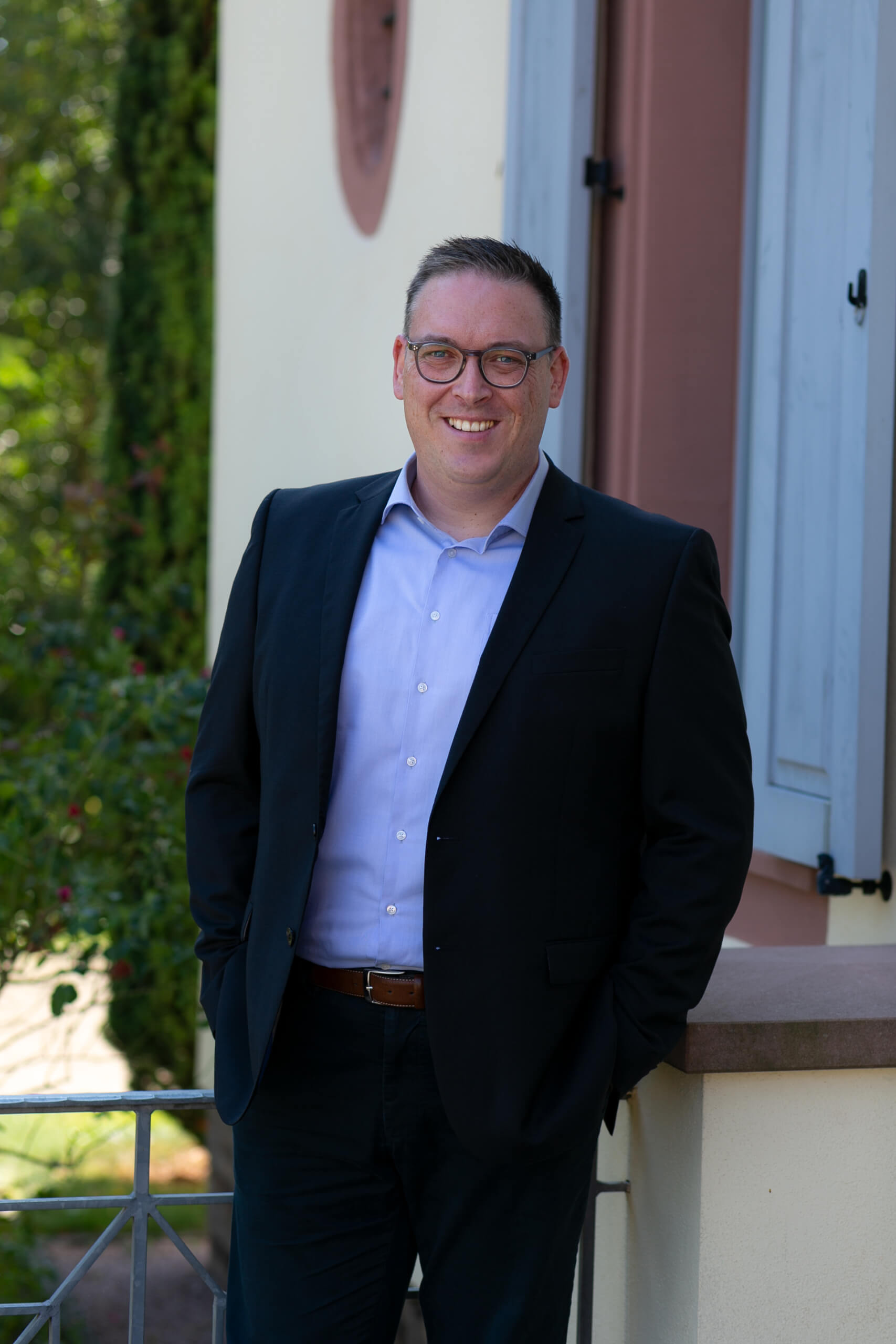 three men laughing while looking in the laptop inside room